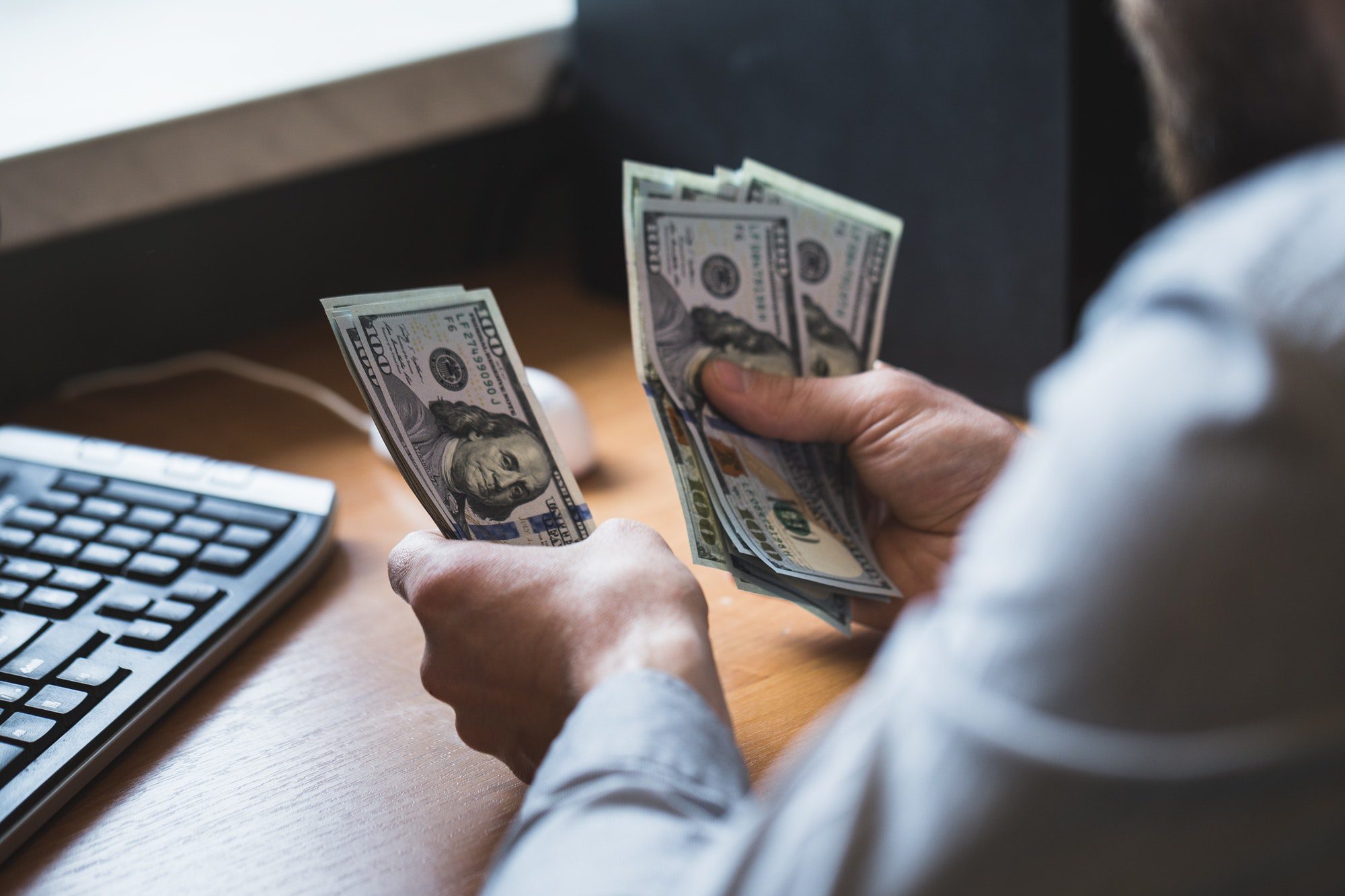 Businessman is counting dollars banknotes, business and financial background