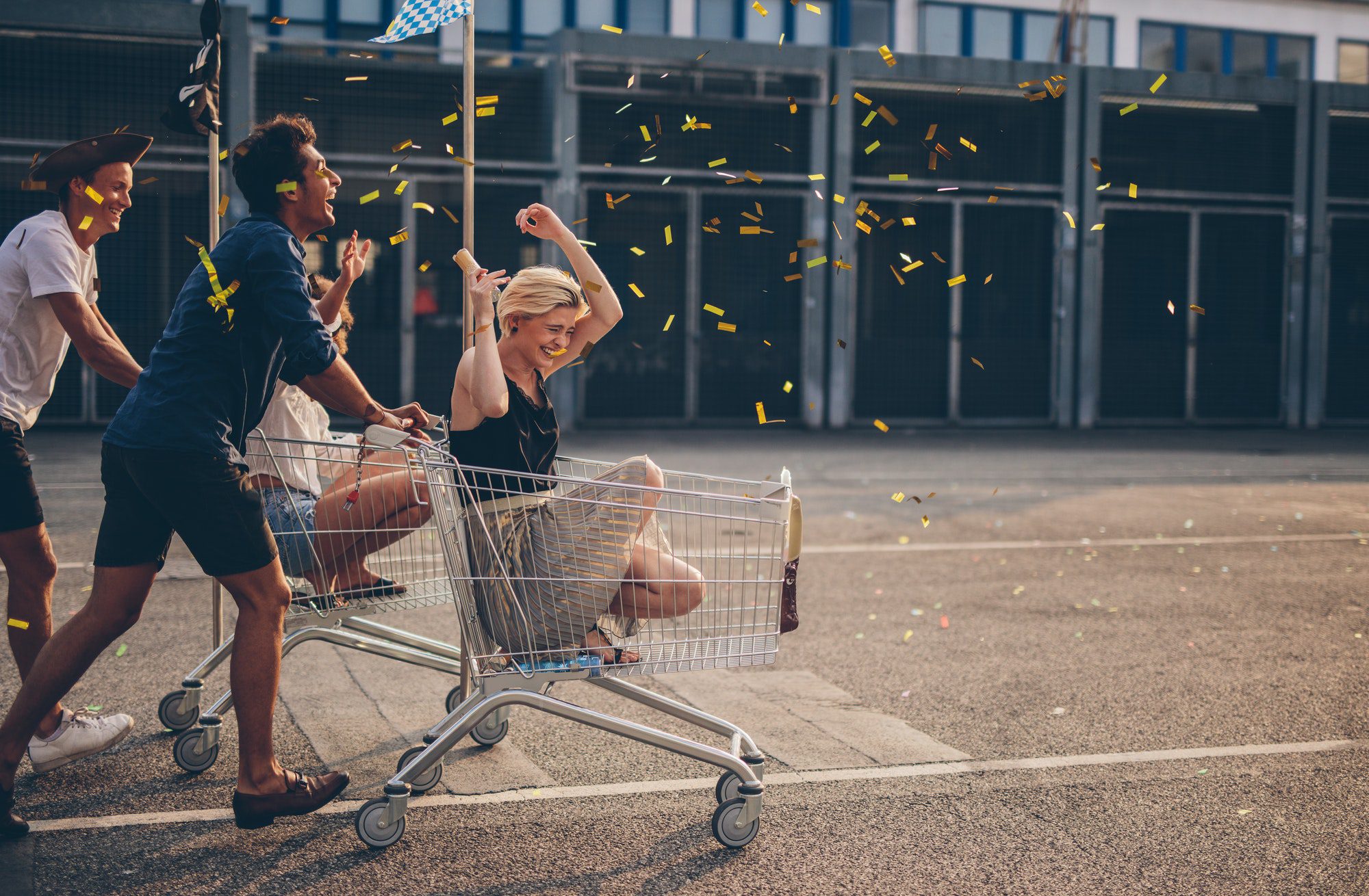 Friends racing with shopping cart