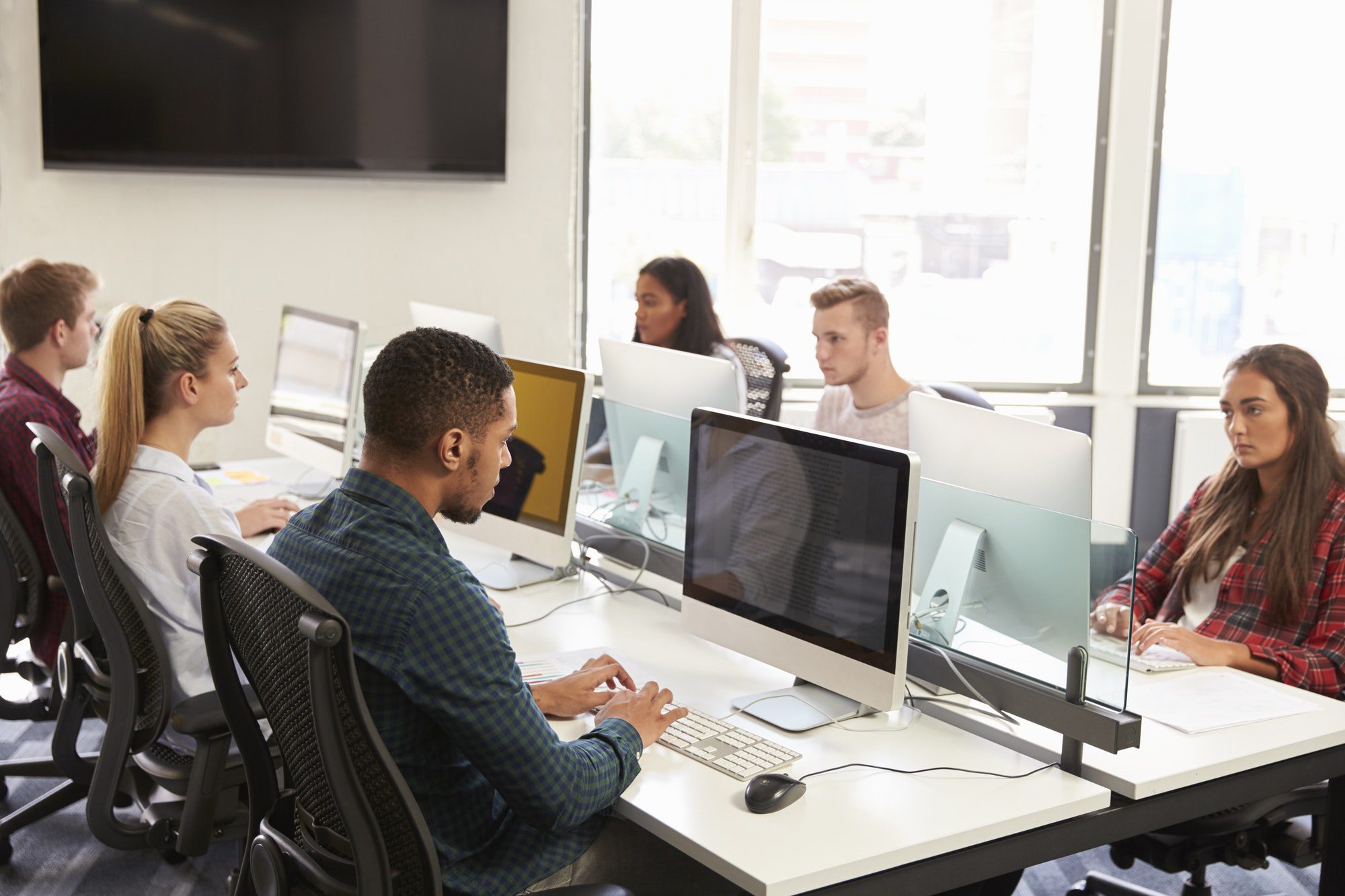 Group Of University Students Using Online Resources