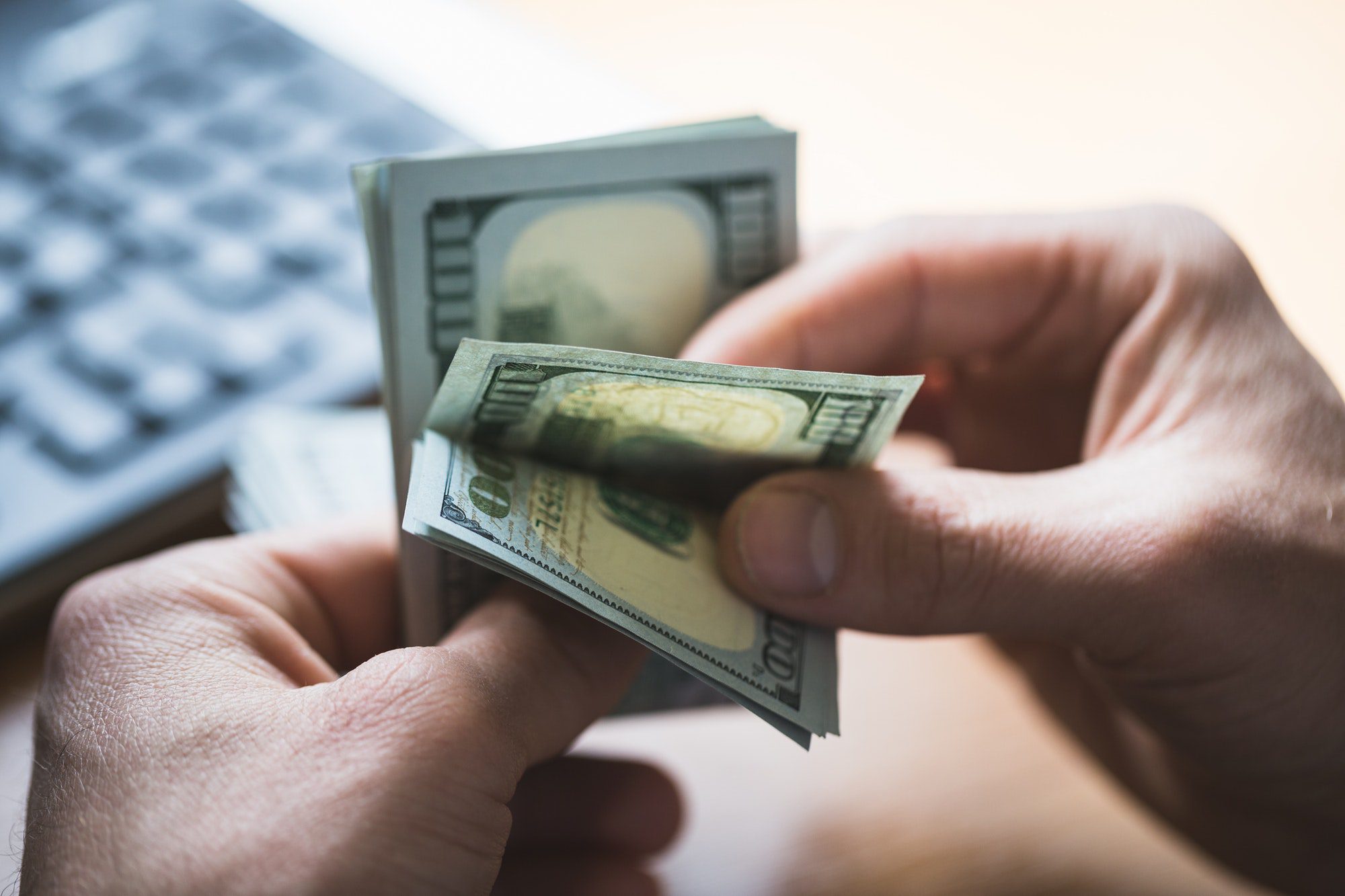 Businessman is counting dollars banknotes, business and financial background