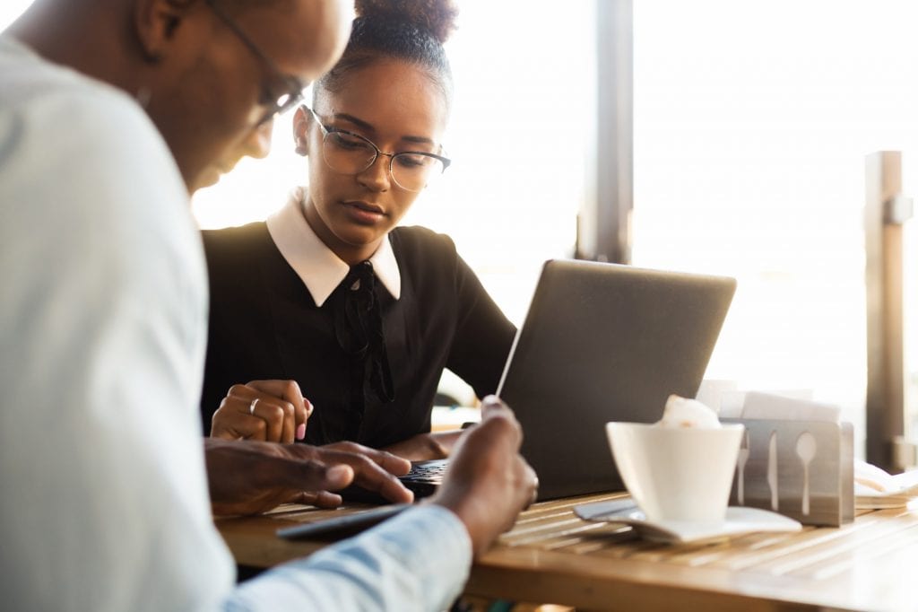 Black African American coworkers doing digital teamwork arround